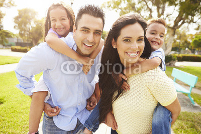 Parents-Giving-Children-Piggyback-Ride-In-Garden.jpg